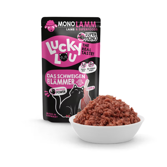 a pouch of cat food lucky lou lamb on black background