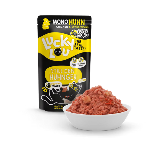 a pouch of lucky lou cat food with chicken on black background