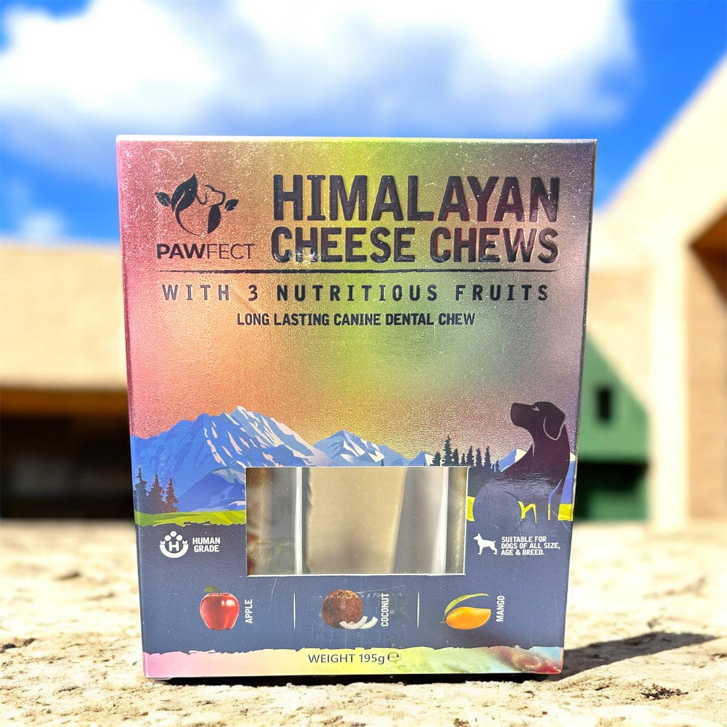 Box of Himalayan Cheese Chews with mountain and dog illustration on a blurred natural background