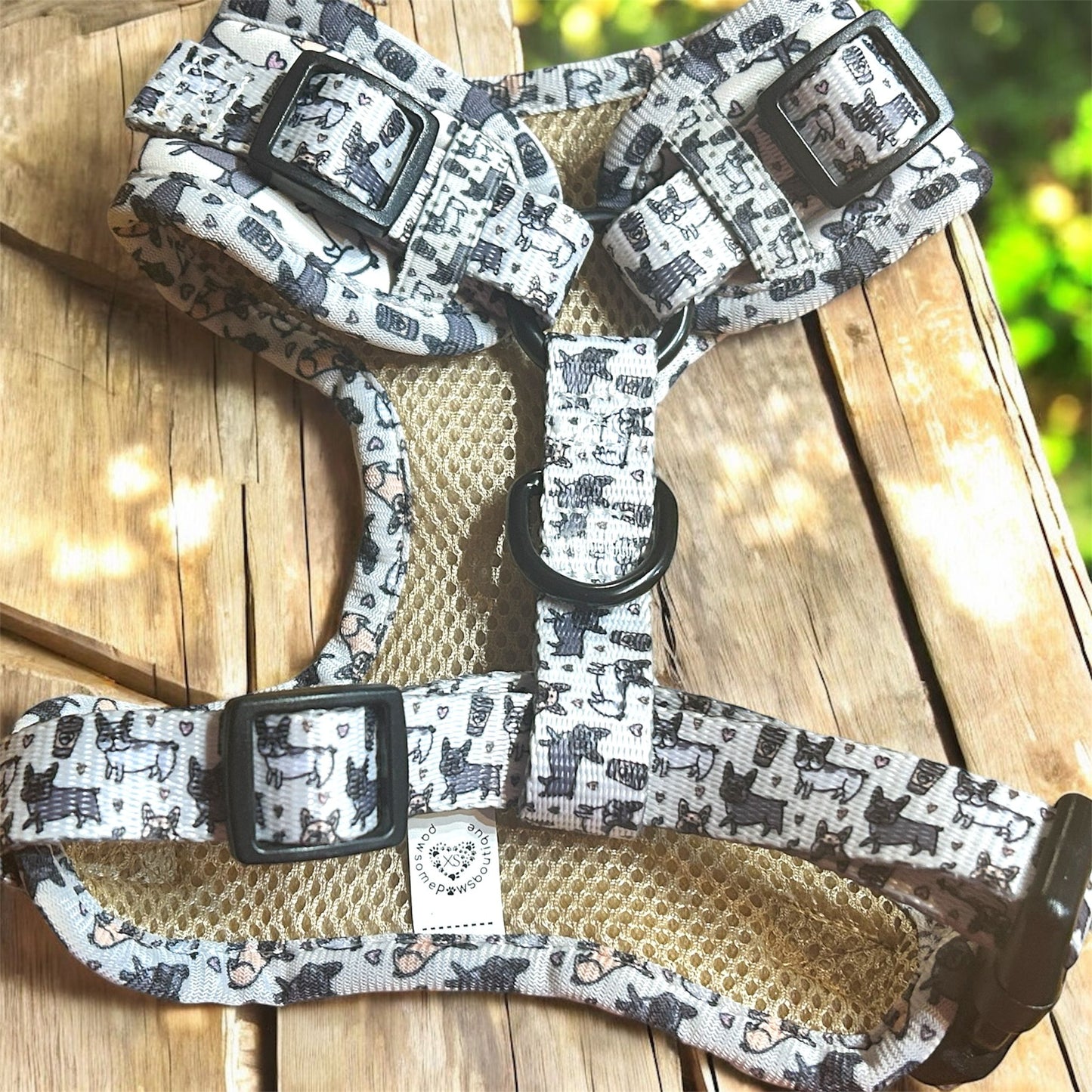 Dog harness with black and white pattern on a wooden surface