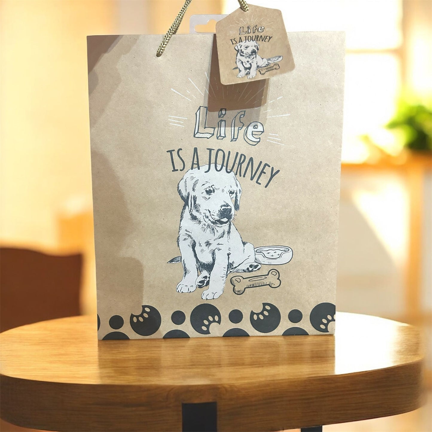 Kraft paper bag with a dog illustration and 'Life is a Journey' text on a wooden surface.