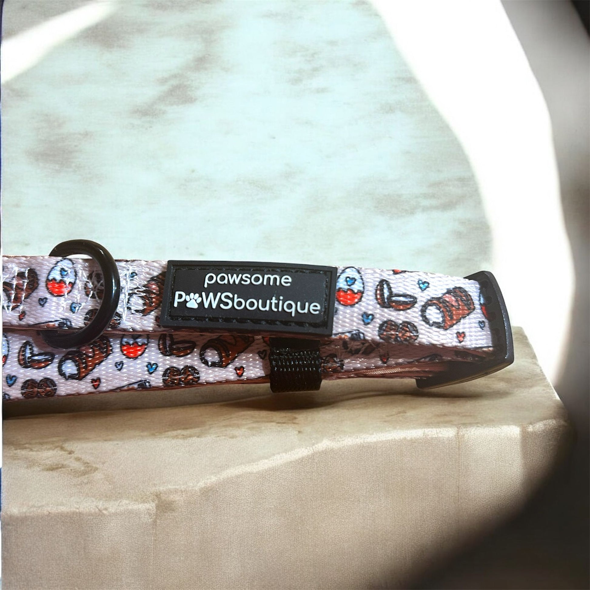 Dog collar with a patterned design and visible brand label on a light background