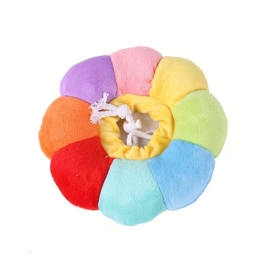 Colorful circular pet toy with a white drawstring on a white background