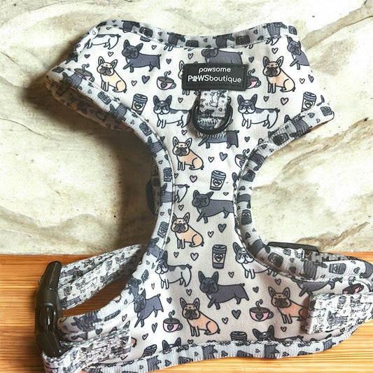 Dog harness with a pattern of dogs and hearts on a wooden surface