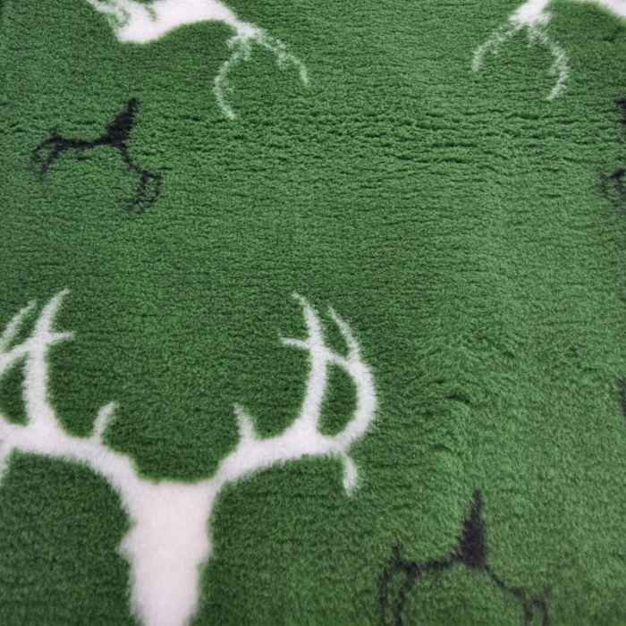 Close-up of a green fabric with deer antler patterns