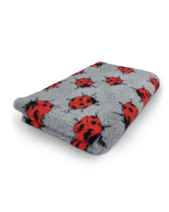Gray blanket with red ladybug pattern on a white background