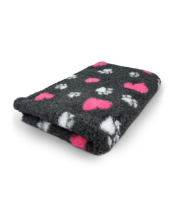 Folded blanket with pink hearts on a white background
