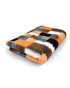Checkered blanket with orange, black, and white pattern on a white background